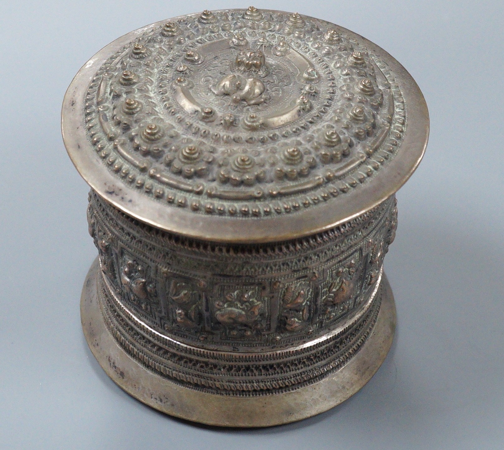 A 19th century Shan people white metal circular betel box and cover, Eastern Burma, height 10.5cm, 266 grams.